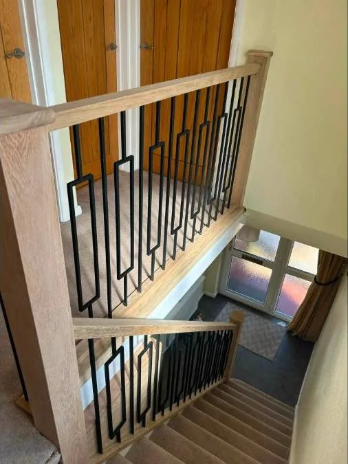 Bespoke oak staircase with black metal spindles
