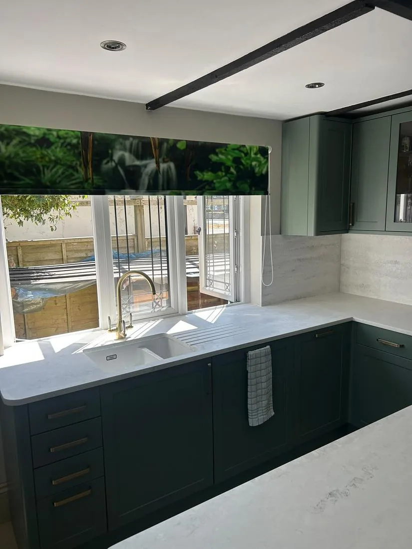 Fitted green shaker kitchen cabinetry